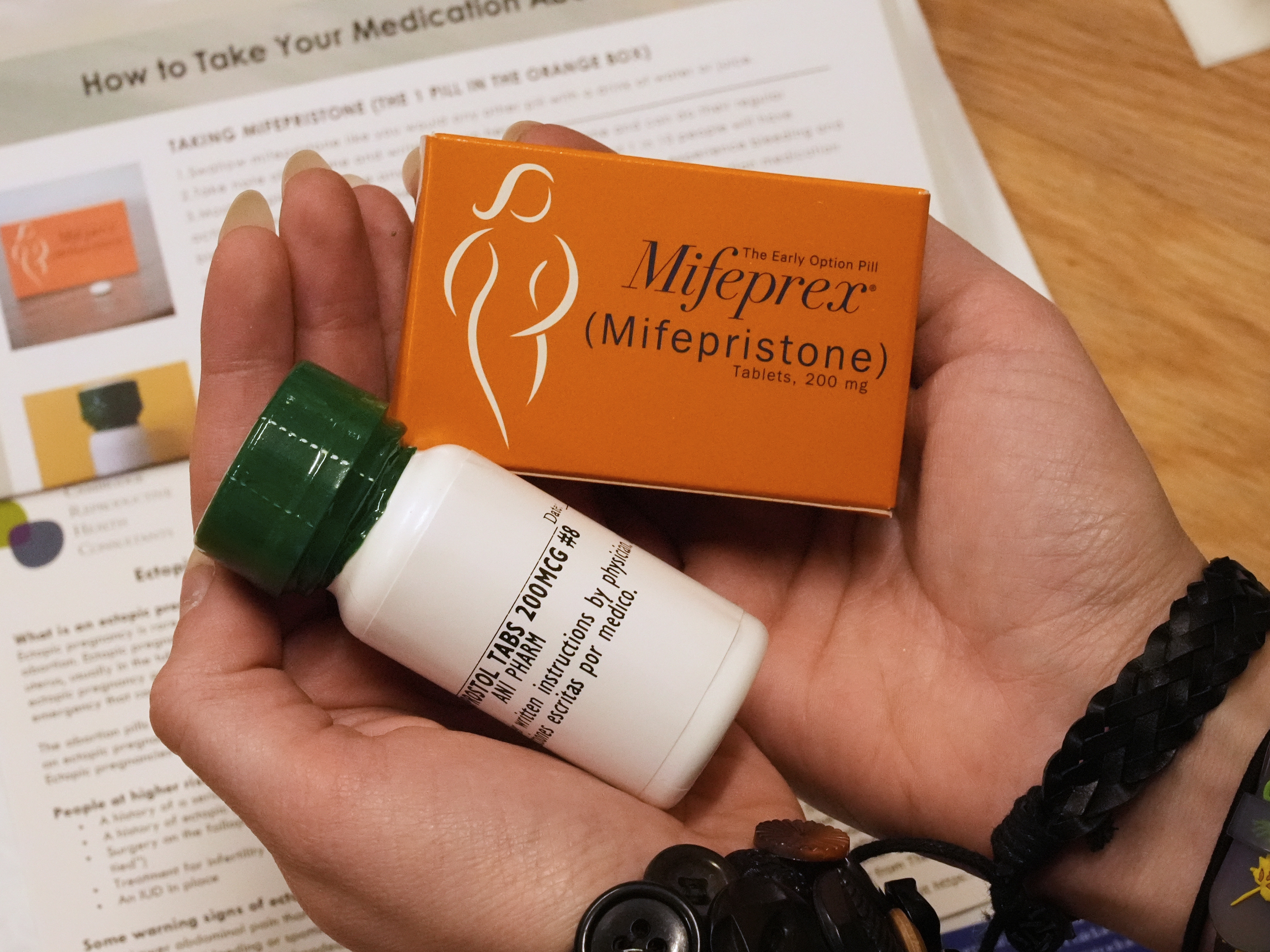 caption: A coordinator at Massachusetts Medication Abortion Access Project shows what the medication abortion kit that is prescribed and mailed via telehealth looks like.
