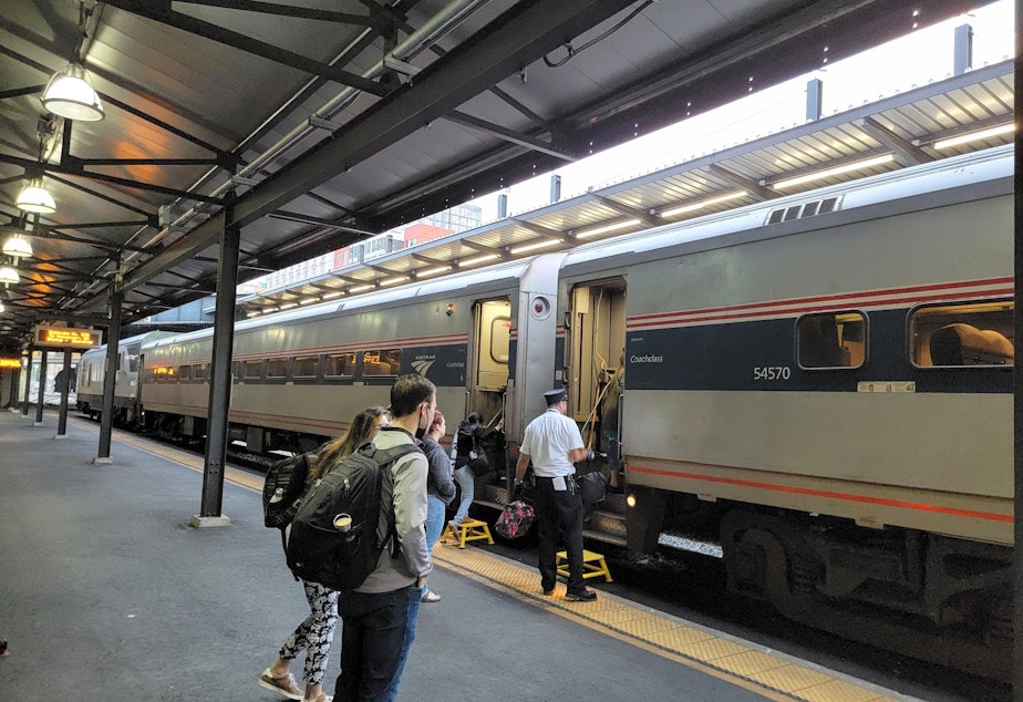 caption: Passengers board the Amtrak Cascades at King Street Station in Seattle on Monday, September 26, 2022.