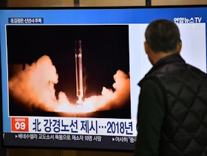 caption: A man watches TV news at a railroad station on Jan. 1 in Seoul, South Korea. While waiting for North Korea's leader to address his nuclear-weapons plans, the program featured file footage of a North Korean missile test.