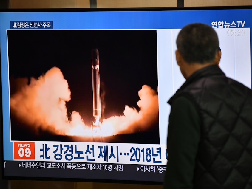 caption: A man watches TV news at a railroad station on Jan. 1 in Seoul, South Korea. While waiting for North Korea's leader to address his nuclear-weapons plans, the program featured file footage of a North Korean missile test.