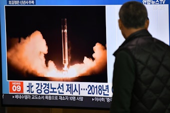 caption: A man watches TV news at a railroad station on Jan. 1 in Seoul, South Korea. While waiting for North Korea's leader to address his nuclear-weapons plans, the program featured file footage of a North Korean missile test.