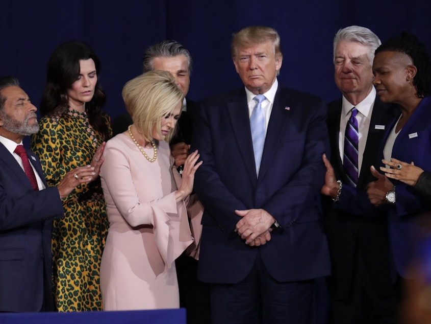 caption: Faith leaders pray with President Trump during a rally for evangelical supporters at the King Jesus International Ministry church in Miami earlier this month.