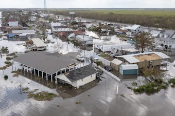 caption: Water surrounds damaged homes in Lafourche Parish, La., after Hurricane Ida in 2021. Many people in Louisiana are still recovering from past hurricanes as this year's hurricane season gets underway. "Anytime we have a community that is still going through a recovery from a previous storm, it just makes them that much more vulnerable," says FEMA Administrator Deanne Criswell.