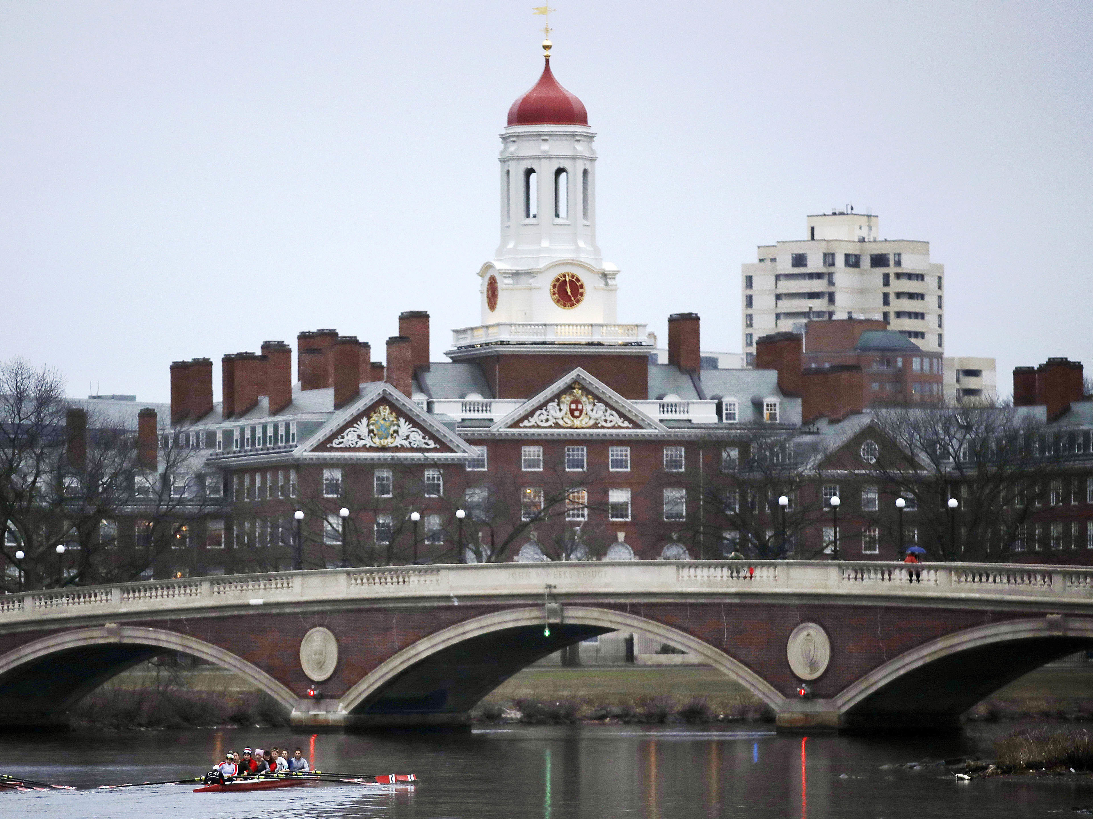 FILE - In this March 7, 2017 file photo, rowers paddle along the Charles River past the Harvard College campus in Cambridge, Mass. (AP Photo/Charles Krupa, File)