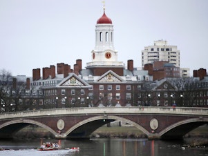 FILE - In this March 7, 2017 file photo, rowers paddle along the Charles River past the Harvard College campus in Cambridge, Mass. (AP Photo/Charles Krupa, File)