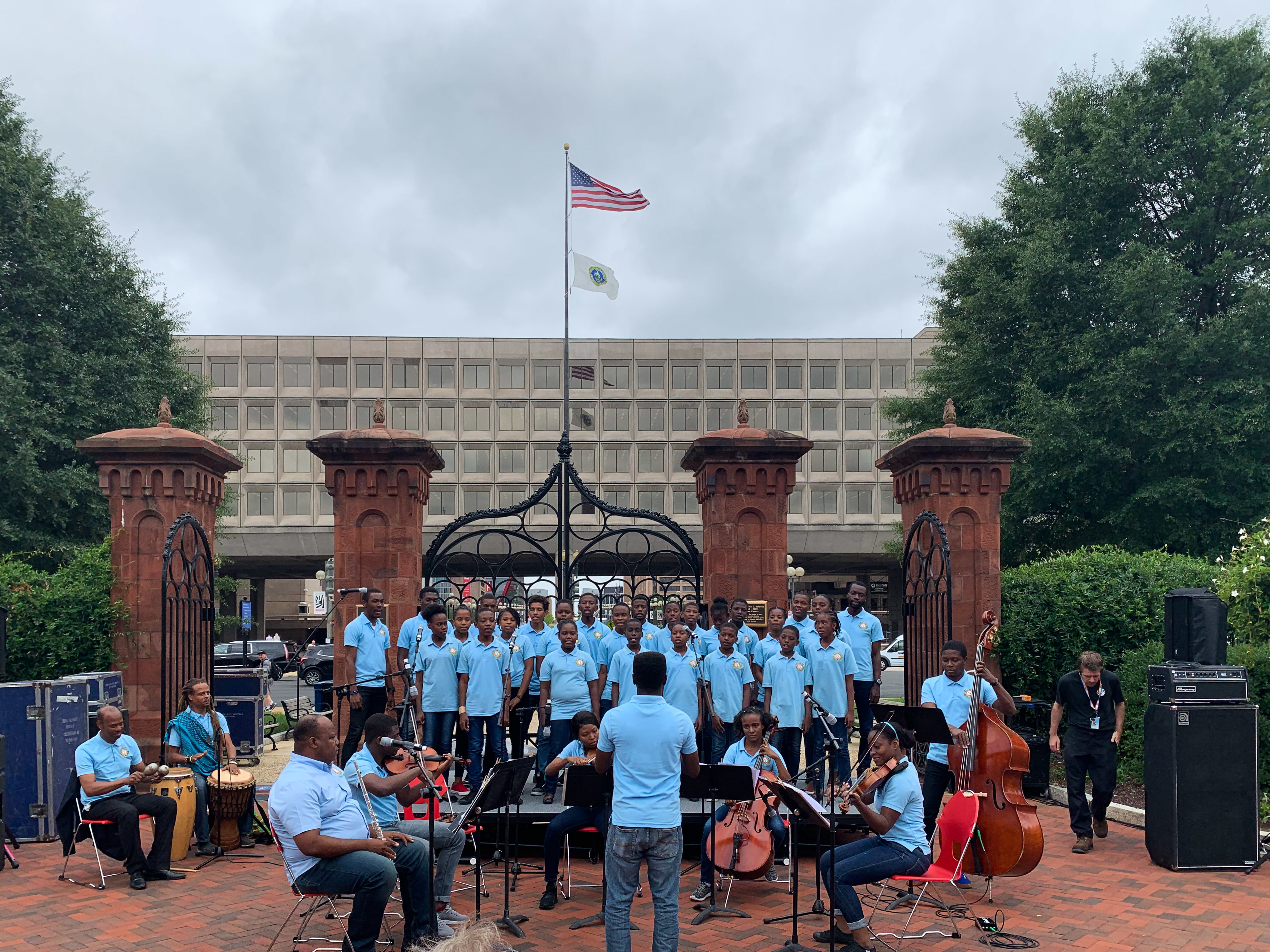caption: Holy Trinity Music School's youth choir and chamber orchestra perform in the Smithsonian's Enid A. Haupt garden in Washington, D.C.