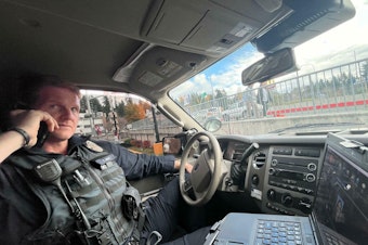 caption: Sgt Casey Hiam of the Bellevue. WA police department on an anti-shoplifting stakeout operation during the holiday shopping season