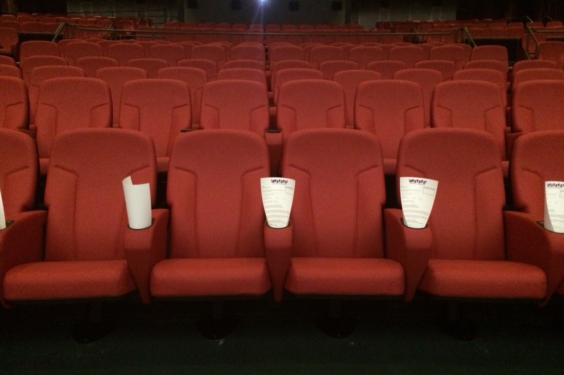 caption: The theater revised its number of seats down from 798 to 570. The seats are leather and offer enough leg room for an average size adult woman to fully extend her legs (claim tested).