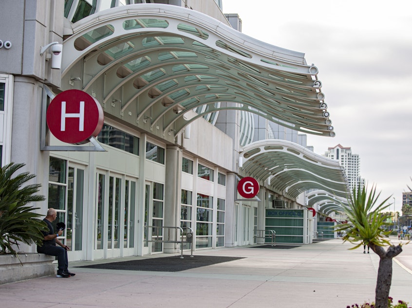 caption: Like last year, the sidewalks around San Diego's convention center are empty, and no one's lined up at the famed Hall H.