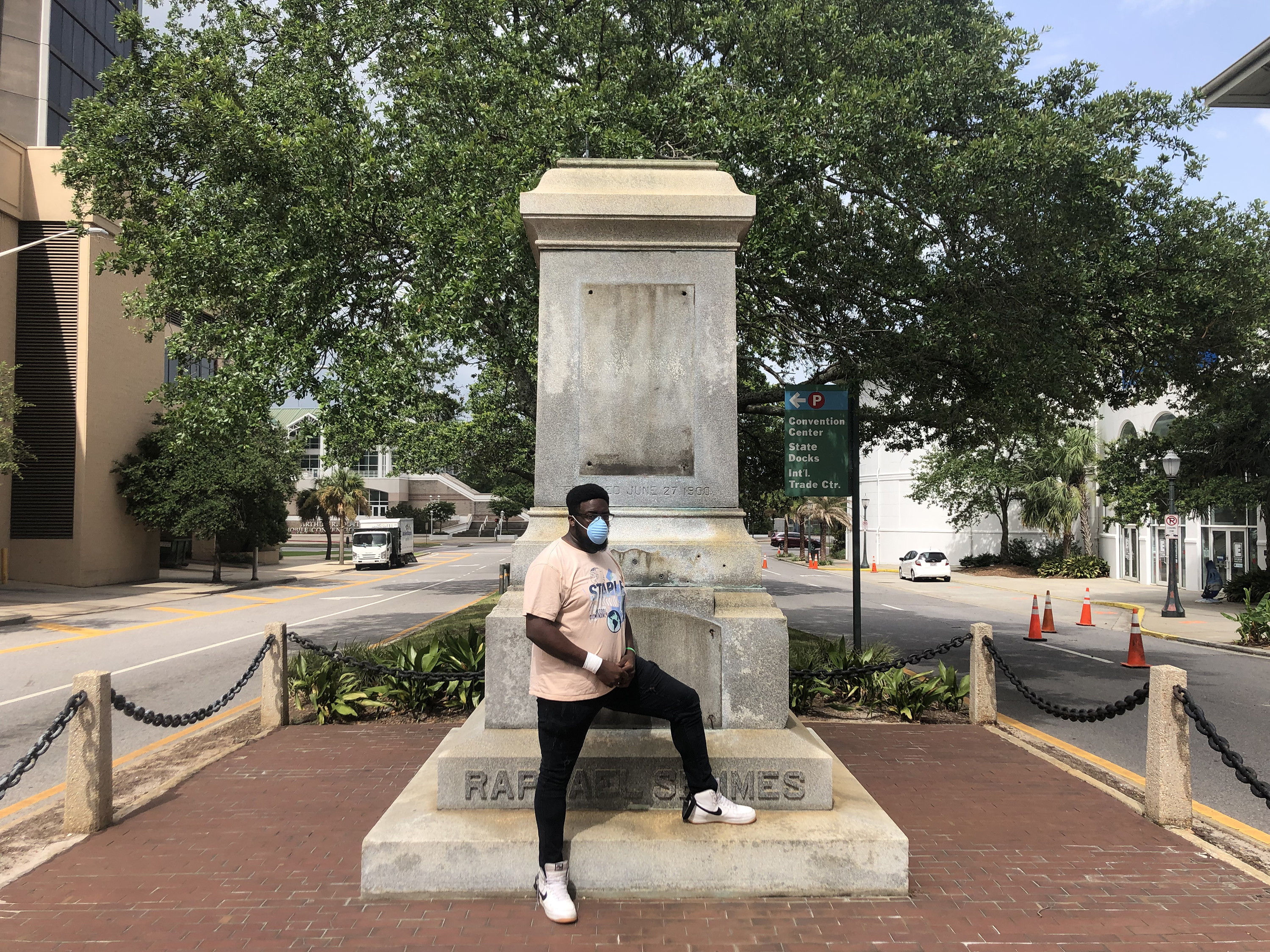 caption: Protest organizer DAntjuan Miller stands by the granite pedestal that remains of a monument to Confederate Navy Adm. Raphael Semmes in Mobile, Ala. "It's like a weight that's lifted off now that it's gone," he says.