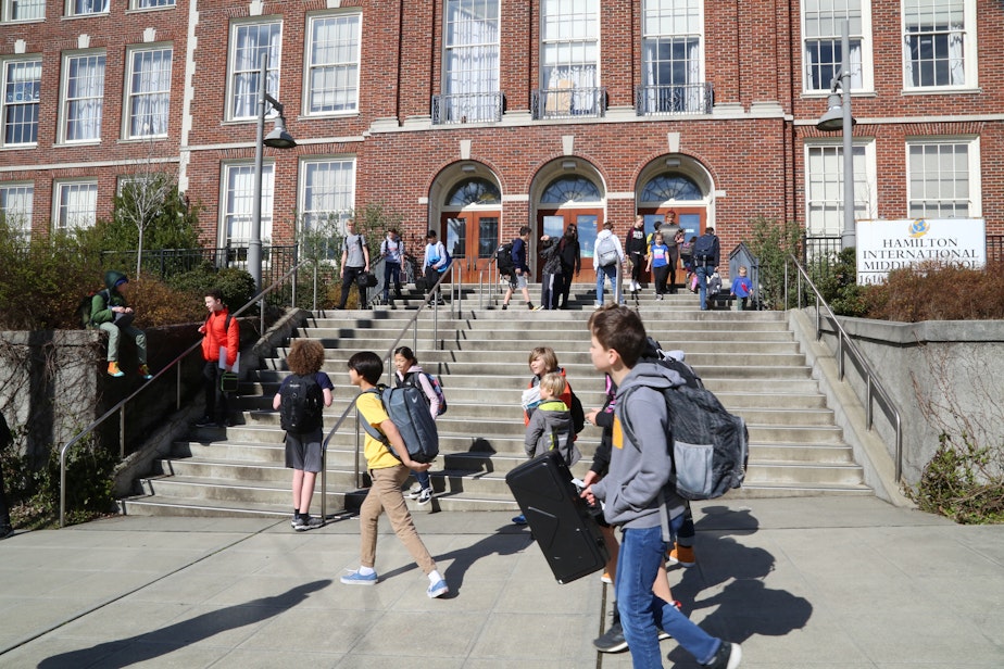 caption: Students leave Hamilton International Middle School on  March, 11, 2020, after Seattle Public Schools decided to close all school buildings in response to the Covid-19 pandemic.