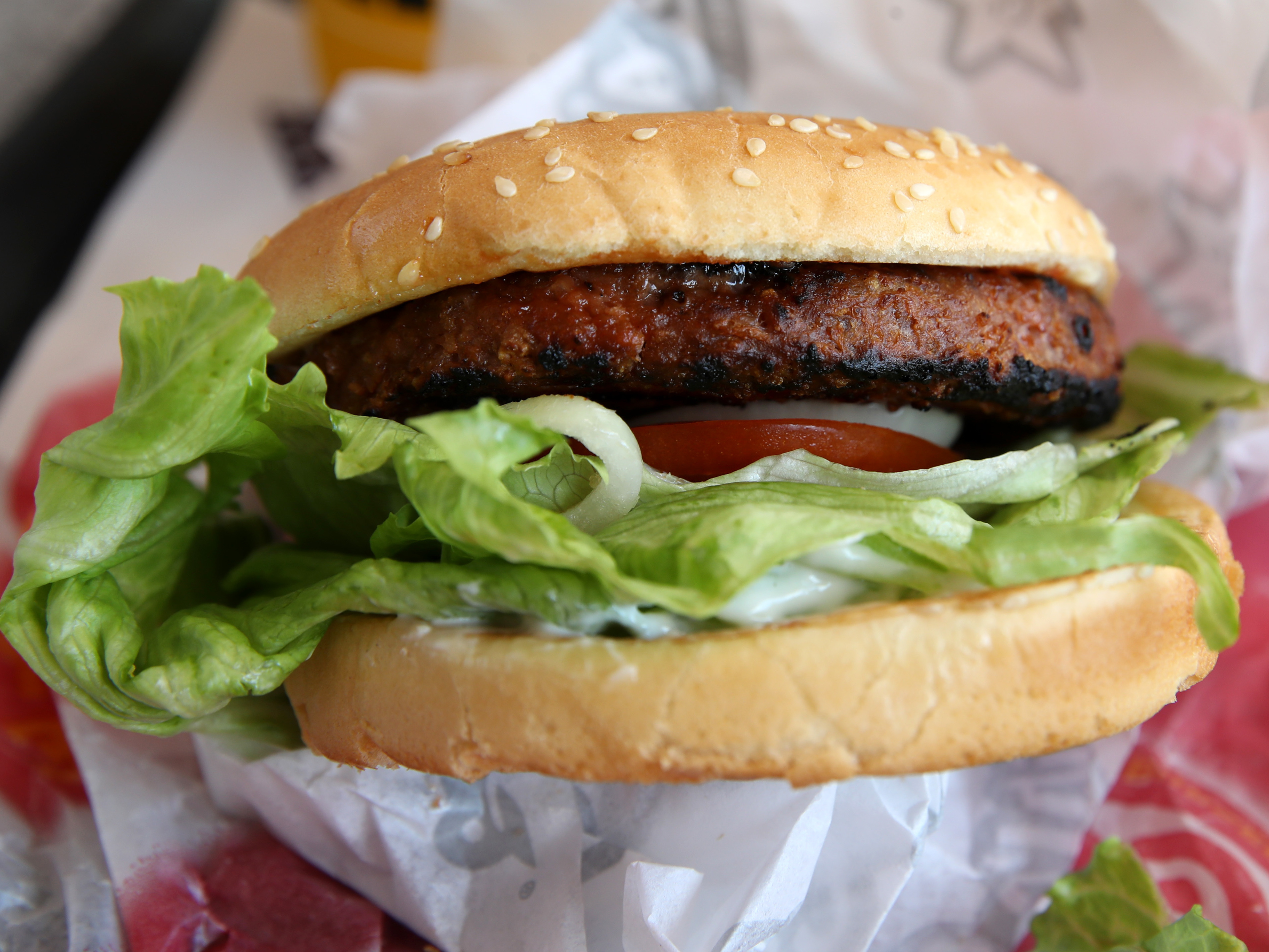 caption: A Beyond Meat burger is displayed at a Carl's Jr. restaurant in San Francisco. The rise of meat alternatives made of plants, or even grown from animal cells, has sparked new laws on food labeling.