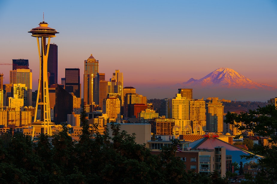 caption: The summer sun sets on Seattle, center of a growing region and state.