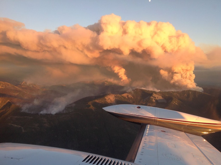 caption: Smoke billows over the Jolly Mountain Fire near Roslyn, Washington, on Friday, Sept. 1, in this aerial image.