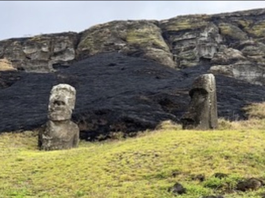 caption: A photo shared by the municipality of Rapa Nui shows damage to the Easter Island statues after a fire.