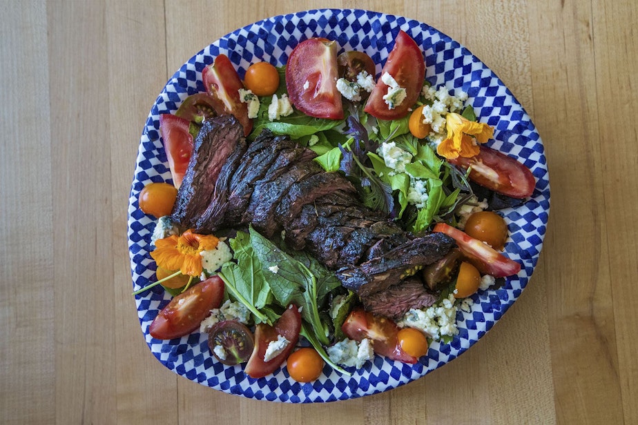 caption: Chef Kathy Gunst's grilled steak salad with blue cheese, tomatoes, and greens. (Jesse Costa/WBUR)