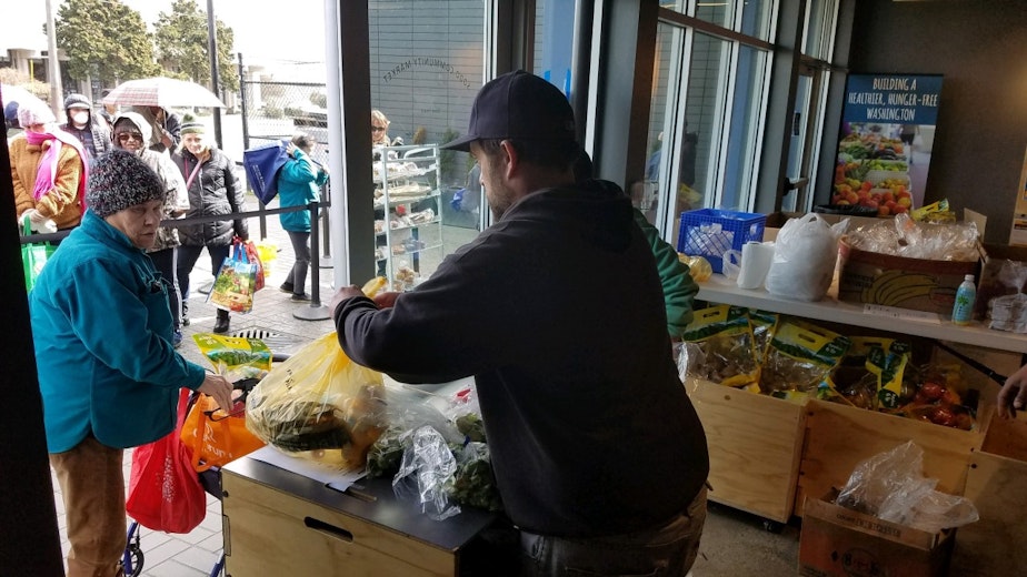 caption: A recent food distribution at Sodo Community Market. Food banks are expecting a big increase in people who need their services, and they are already having a hard time stocking their shelves. 