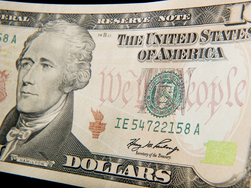 caption: A close-up of the front of the US 10-dollar bill bearing the portrait of Alexander Hamilton, America's first Treasury Secretary.