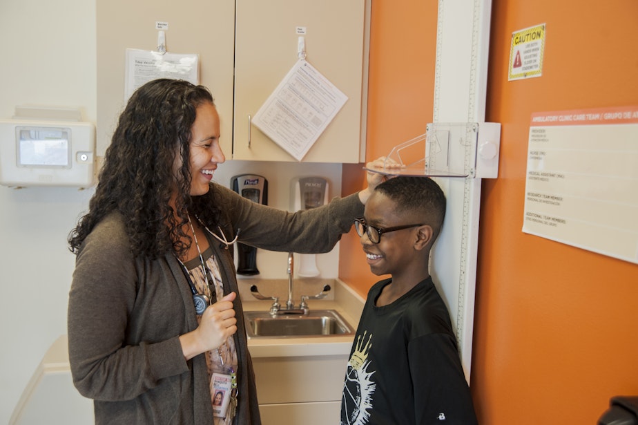 caption: Dr. Shaquita Bell with her patient Jonah Harris at Odessa Brown Children's Clinic. 