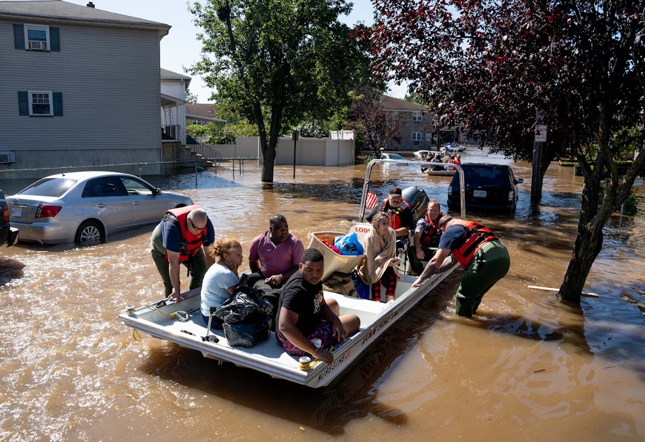 caption: Members of the fire department in Lodi, N.J., perform water rescues of trapped residents following torrential rains from the remnants of Hurricane Ida on Thursday.