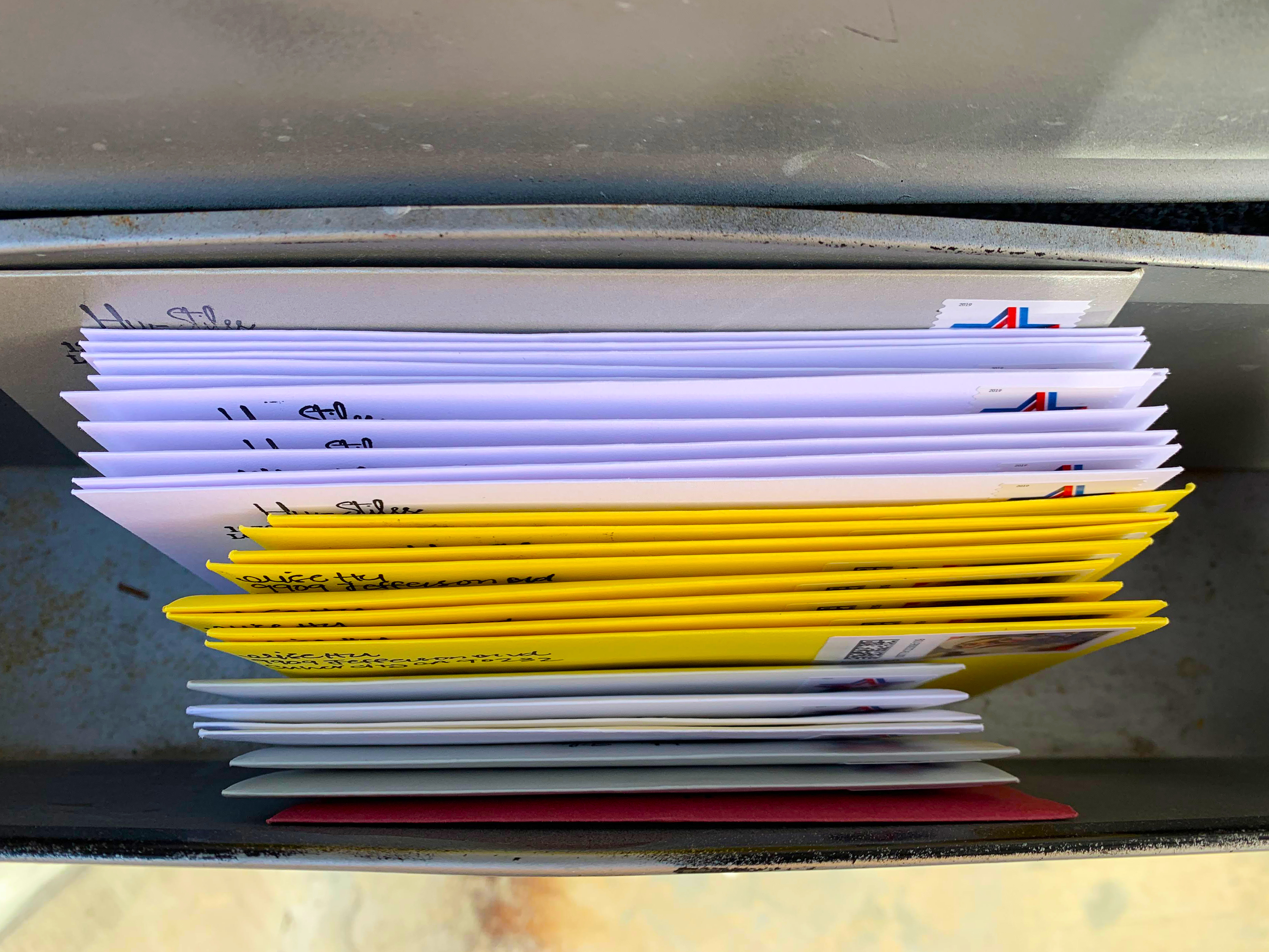 caption: The first batch of handwritten cards and letters, awaiting USPS pickup in the mailbox.