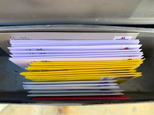 caption: The first batch of handwritten cards and letters, awaiting USPS pickup in the mailbox.