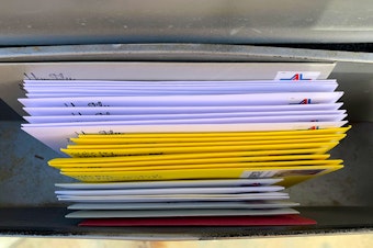 caption: The first batch of handwritten cards and letters, awaiting USPS pickup in the mailbox.