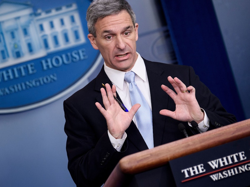 caption: Acting Director of the U.S. Citizenship and Immigration Services Ken Cuccinelli speaks during a briefing at the White House on Monday. Trump administration officials announced new rules that aim to deny permanent residency to migrants who may need to use food stamps, Medicaid and other public benefits.