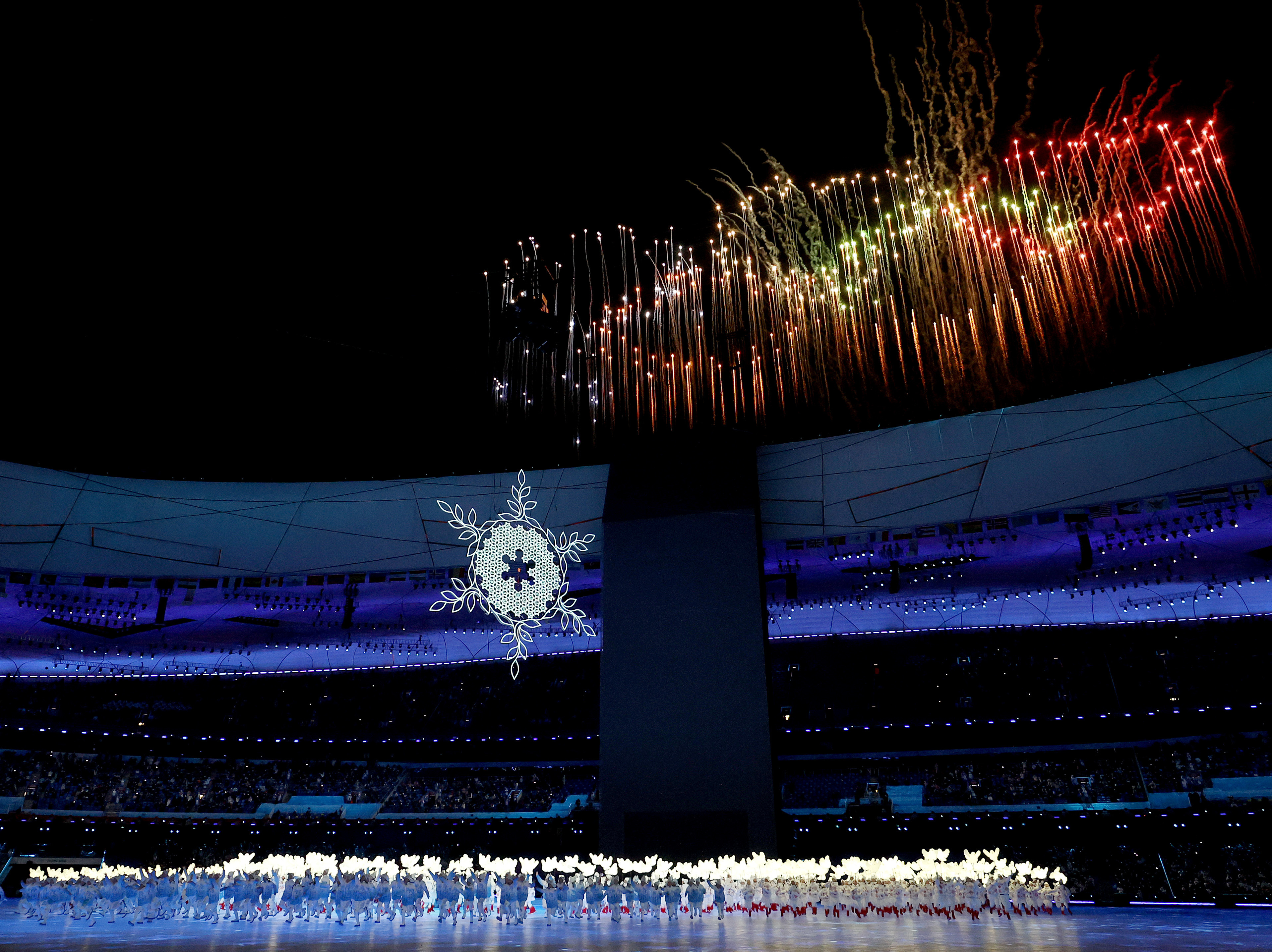 caption: A firework display is seen during the opening ceremony of the 2022 Winter Olympics at the Beijing National Stadium on Friday.