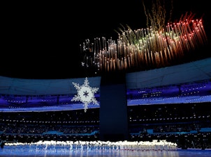 caption: A firework display is seen during the opening ceremony of the 2022 Winter Olympics at the Beijing National Stadium on Friday.