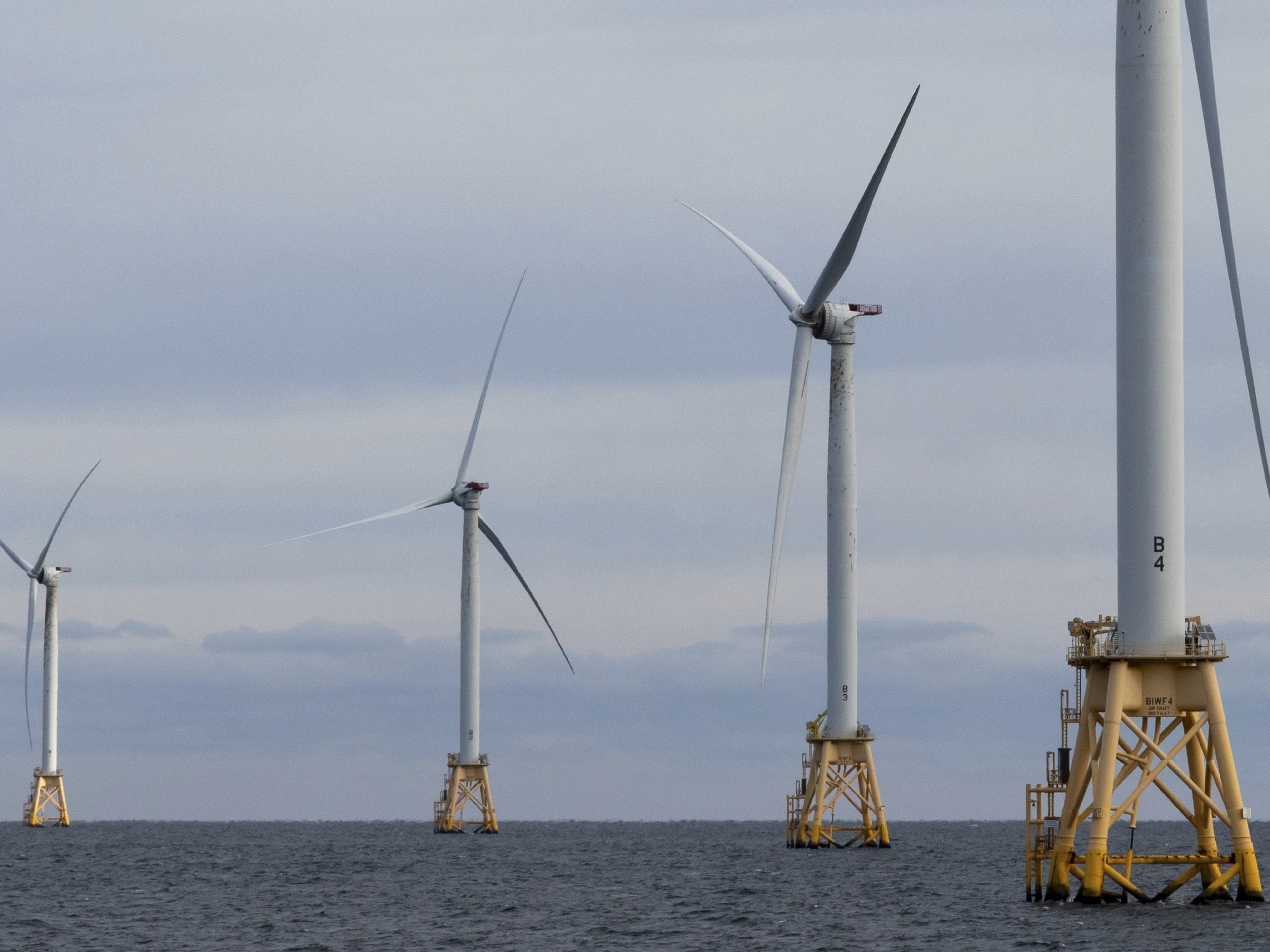 caption: The Biden administration says some efforts to reduce greenhouse gas emissions won't go away after President-elect Trump takes office. Renewable energy projects, like the Block Island Wind Farm off the Rhode Island coast, will continue to operate and others already in the development pipeline will continue to be built.