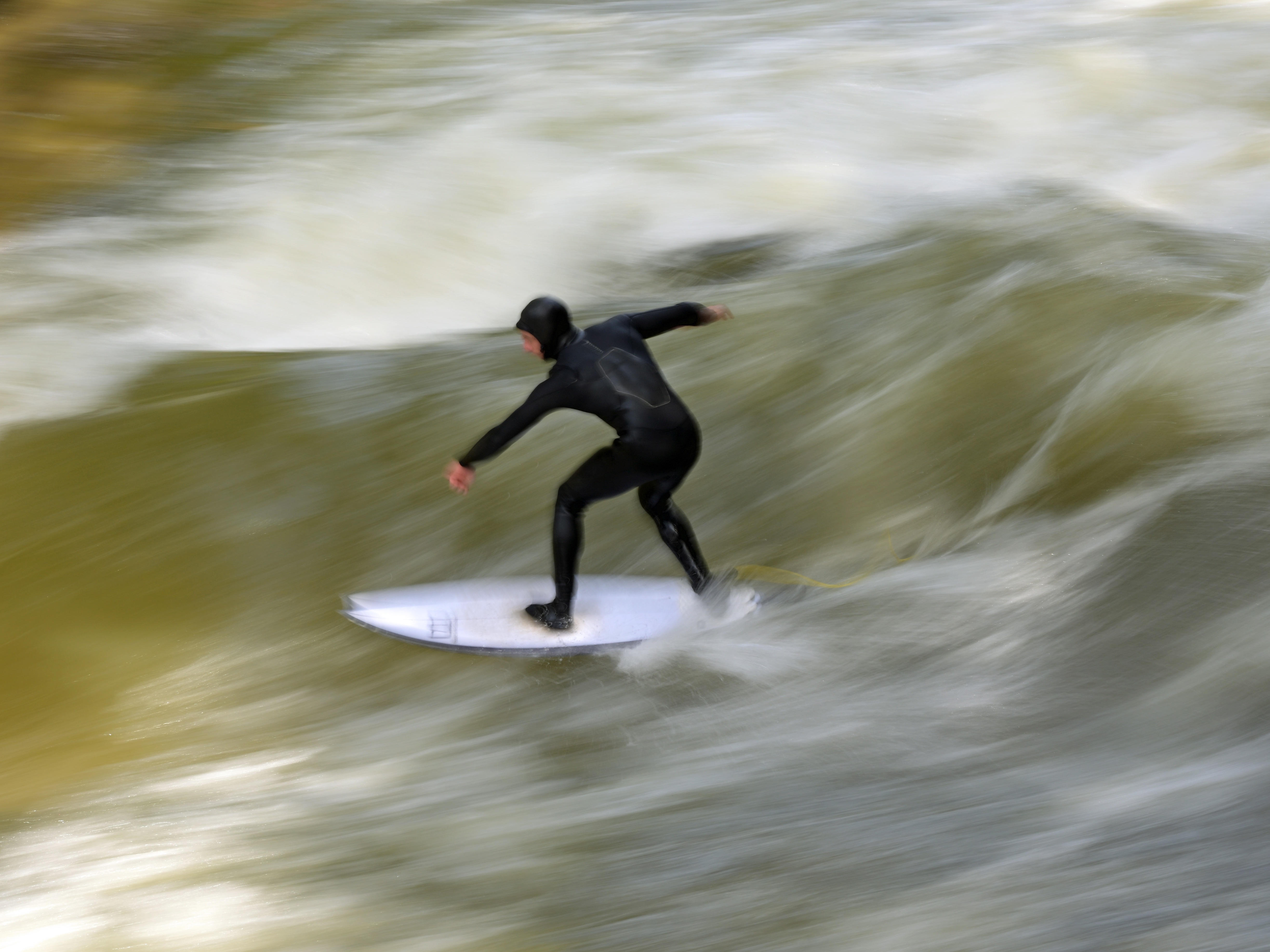 caption: A man in a wetsuit surfs on the Eisbach wave in Munich's English Garden on Oct. 7, 2025, about a month before the wave vanished.