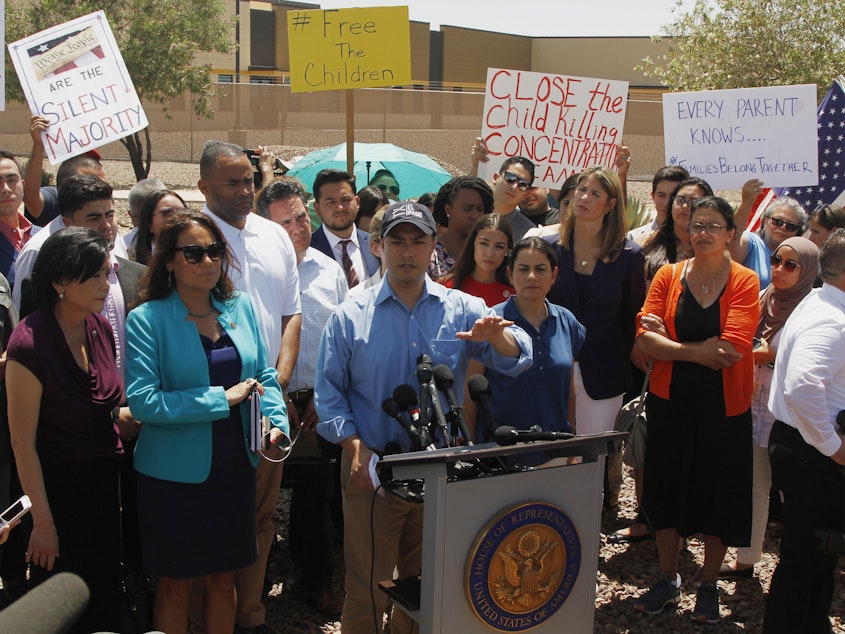 caption: Rep. Joaquin Castro, D-Texas, speaks alongside members of the Hispanic Caucus after touring the Border Patrol station in Clint, Texas, on Monday.