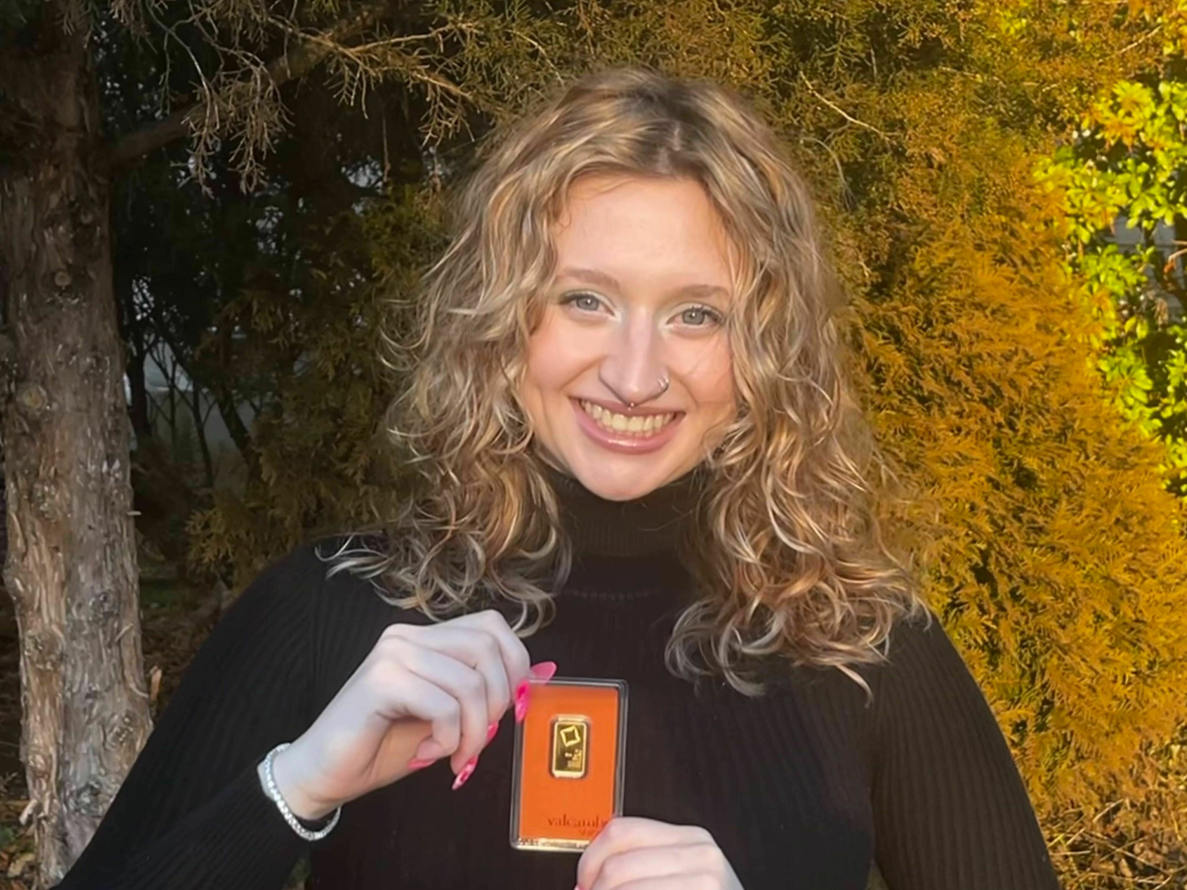 caption: Julia Grugan, 20, a senior at Temple University recently made one of her first major investments: A 10 gram gold bar.