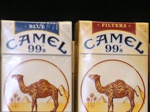 caption: Camel cigarettes, manufactured by Reynolds American, are displayed at a tobacco shop in San Francisco in July 2014. Reynolds was one of the tobacco companies to voluntarily adopt child labor policies that exceed the requirements of U.S. law.