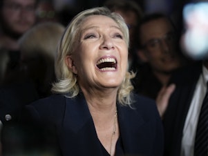 caption: French far right leader Marine Le Pen reacts as she meets supporters and journalists after the release of projections based on the actual vote count in select constituencies on Sunday in Henin-Beaumont, northern France. 