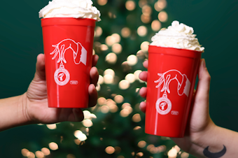 caption: Starbucks Workers United members hope to win over customers who might not be thrilled with the strike by offering an even more exclusive commemorative item: A union-designed red cup with the Starbucks Workers United logo on the front.