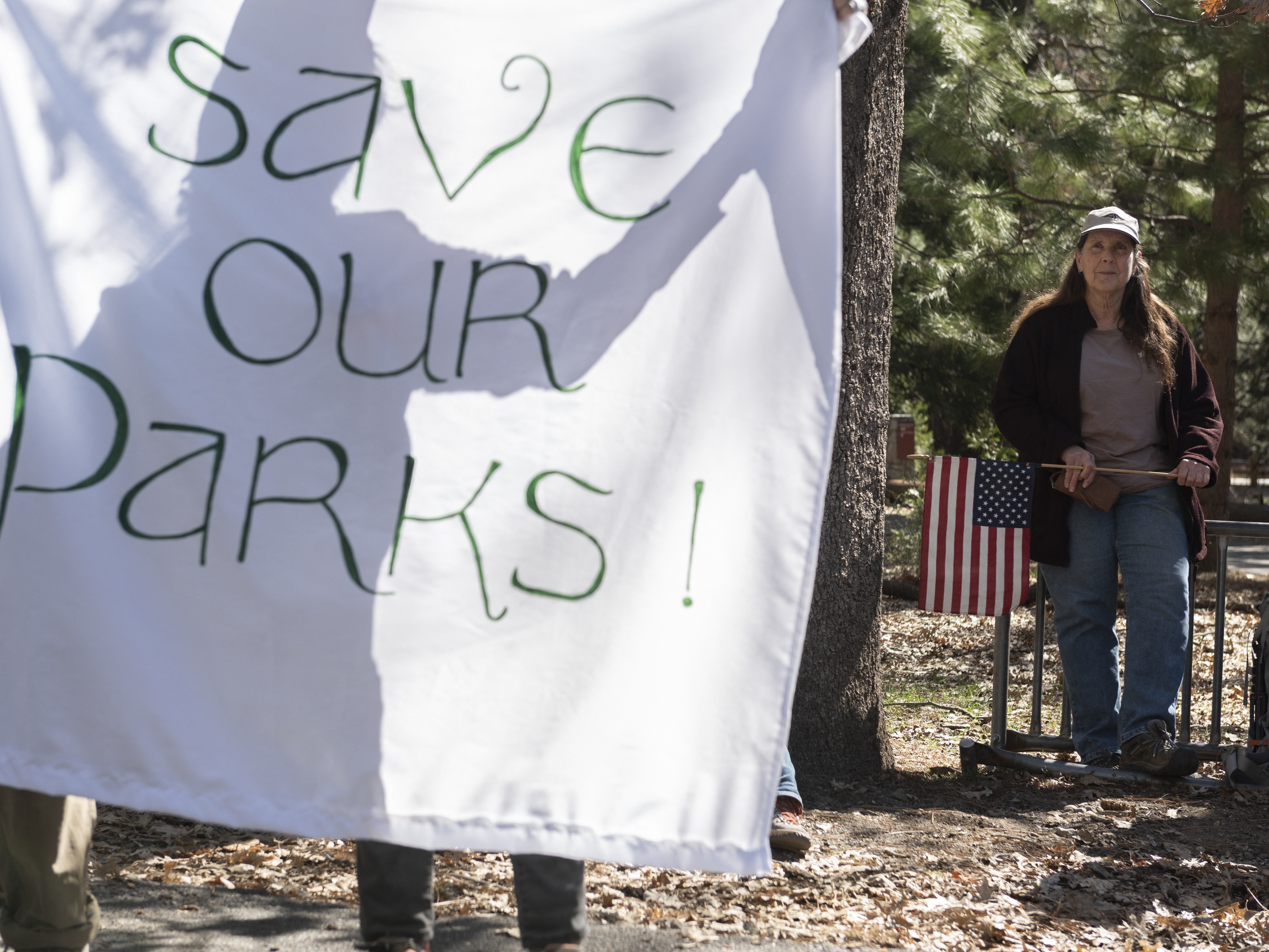 caption: People demonstrate during a protest against federal employee layoffs at Yosemite National Park, California on March 1, 2025. Many workers at the U.S. Department of Interior and other agencies are being reinstated following court orders.