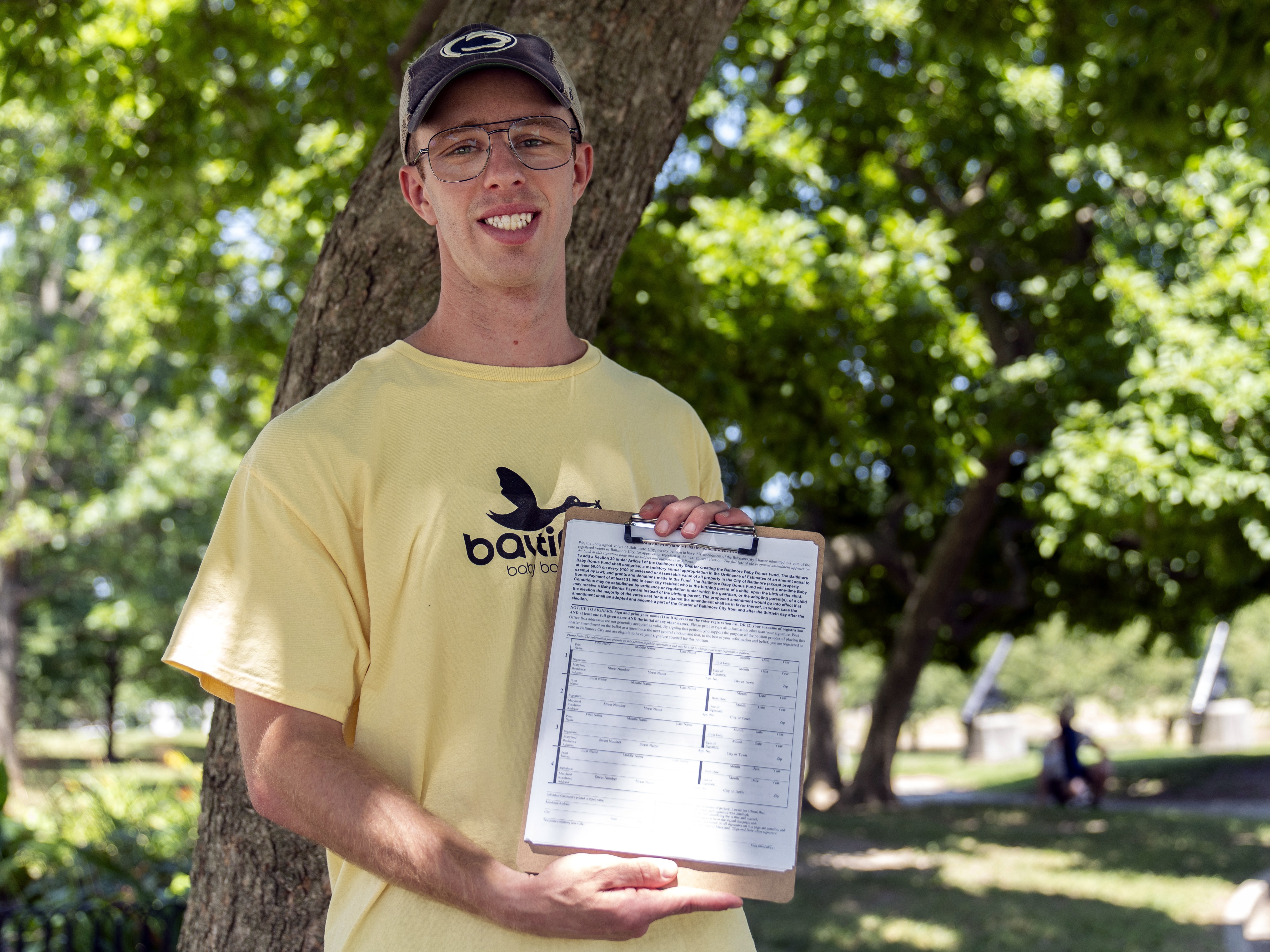 caption: Nate Golden, president of the Maryland Child Alliance, holds a petition form for the Baltimore Baby Fund, on Wednesday in Baltimore.