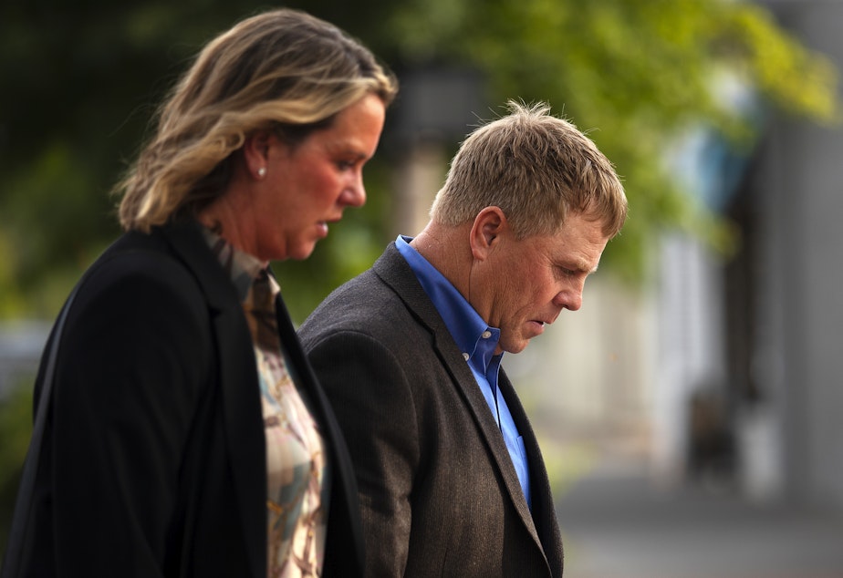 caption: Cody Easterday walks with his wife, Debby, from the Federal Courthouse on South Third Street after being sentenced to 11 years in prison, on Tuesday, October 4, 2022, in Yakima.