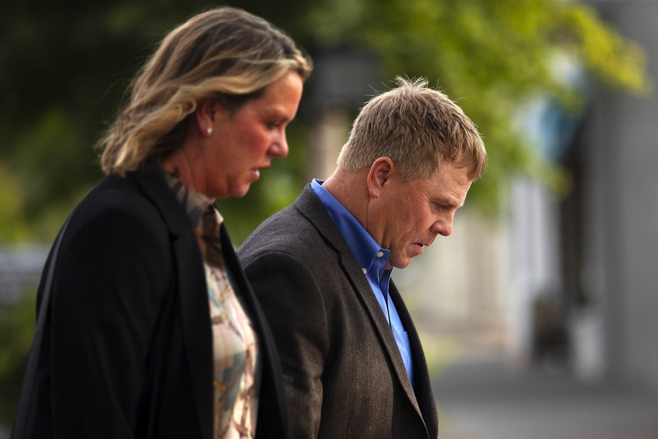 caption: Cody Easterday walks with his wife, Debby, from the Federal Courthouse on South Third Street after being sentenced to 11 years in prison, on Tuesday, October 4, 2022, in Yakima.