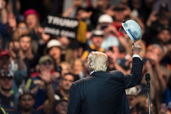US Republican presidential candidate Donald Trump holds a miner's helmet up after speaking during a rally May 5, 2016 in Charleston, West Virginia. BRENDAN SMIALOWSKI/AFP/Getty Images
