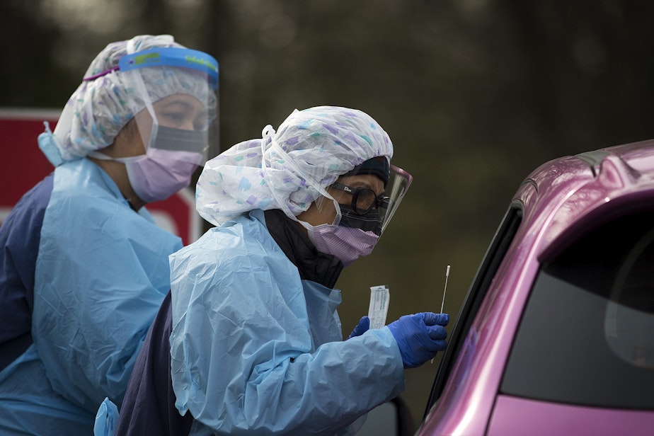caption: UW Medicine nurses test a patient for coronavirus on March 17, 2020, at the University of Washington Northwest Outpatient Medical Center drive-through testing area in North Seattle. 