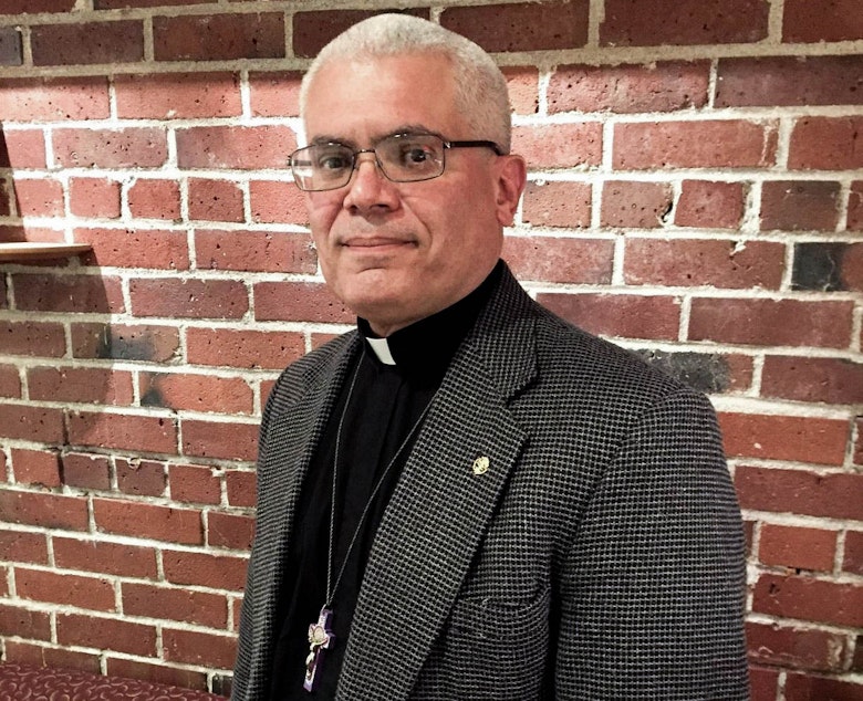 caption: Father Antonio Illas was federal immigration agent for 25 years before becoming a priest.