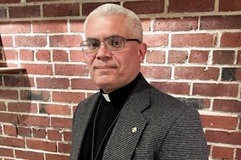 caption: Father Antonio Illas was federal immigration agent for 25 years before becoming a priest.