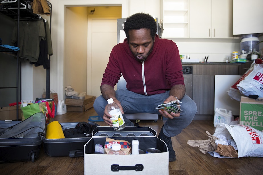 caption: Jordan packs his belongings at his studio apartment on Tuesday, February 26, 2019, after receiving an eviction notice, on 4th Avenue South in Seattle.