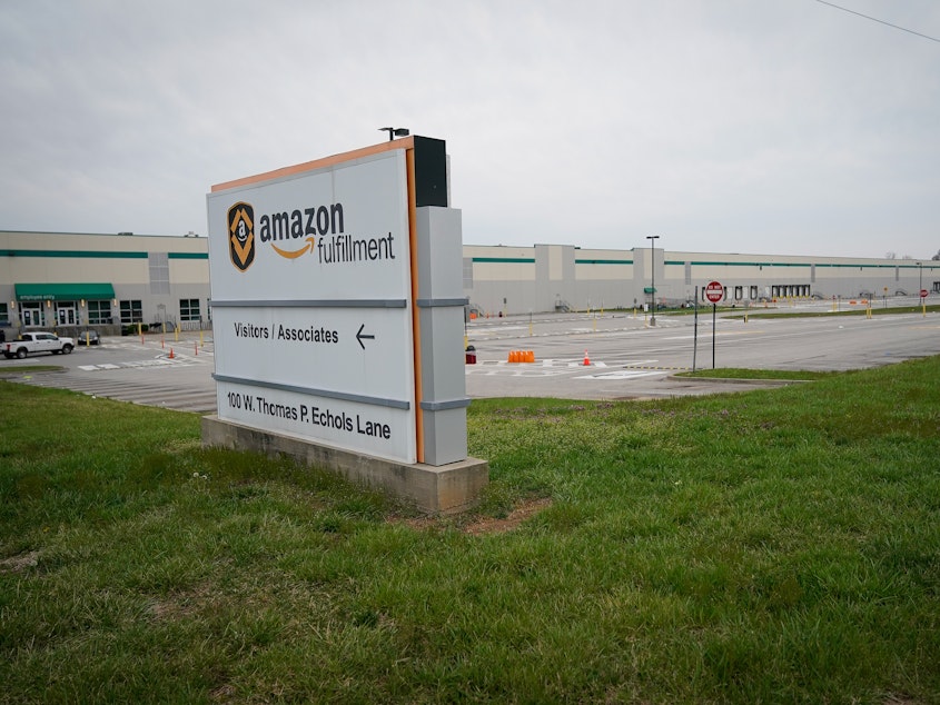 caption: Empty parking lots surround an Amazon distribution center in Shepherdsville, Ky., that has been closed for cleaning after several employees tested positive for COVID-19.