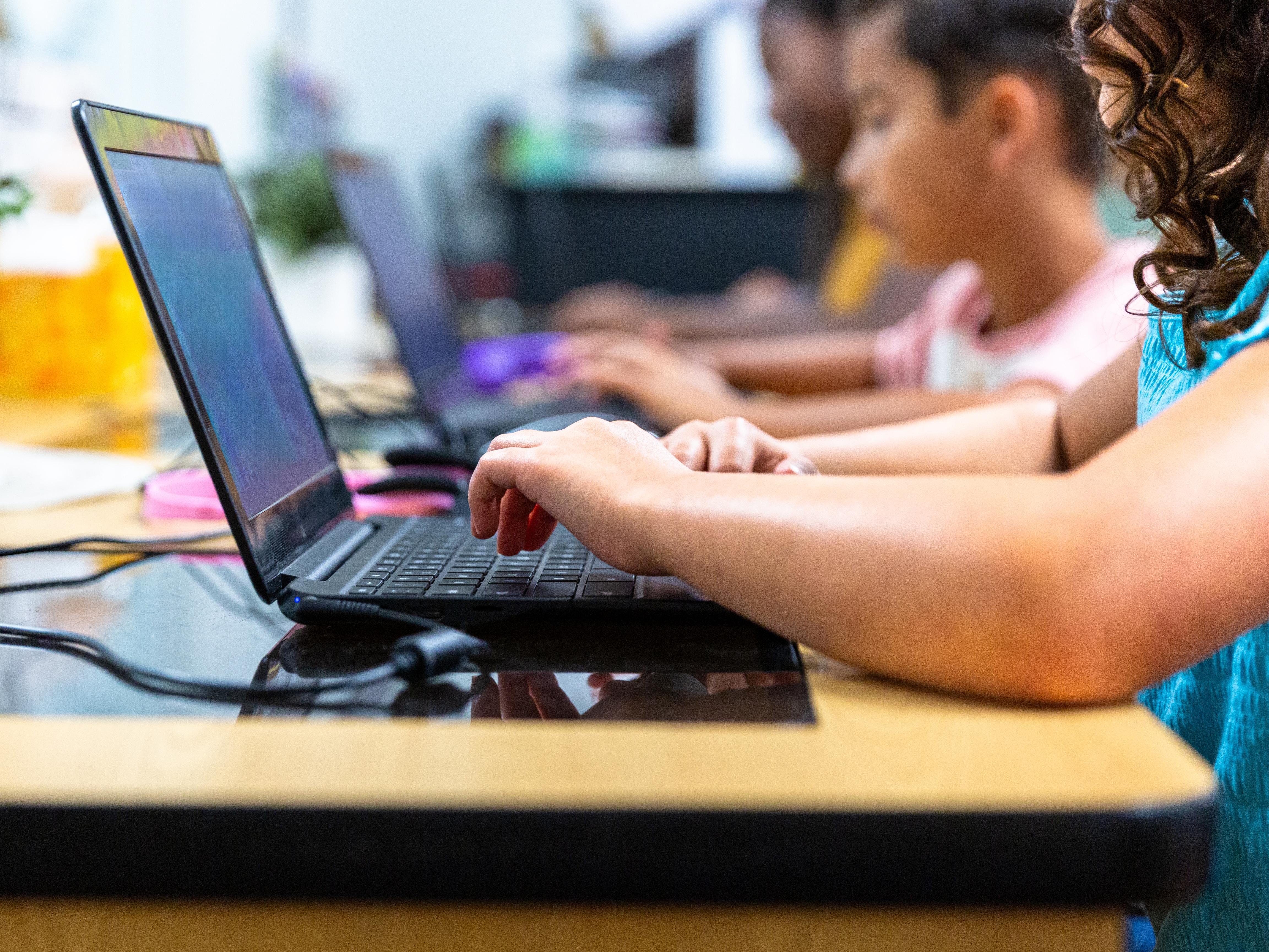 Elementary Students learning in the computer lab with their teacher