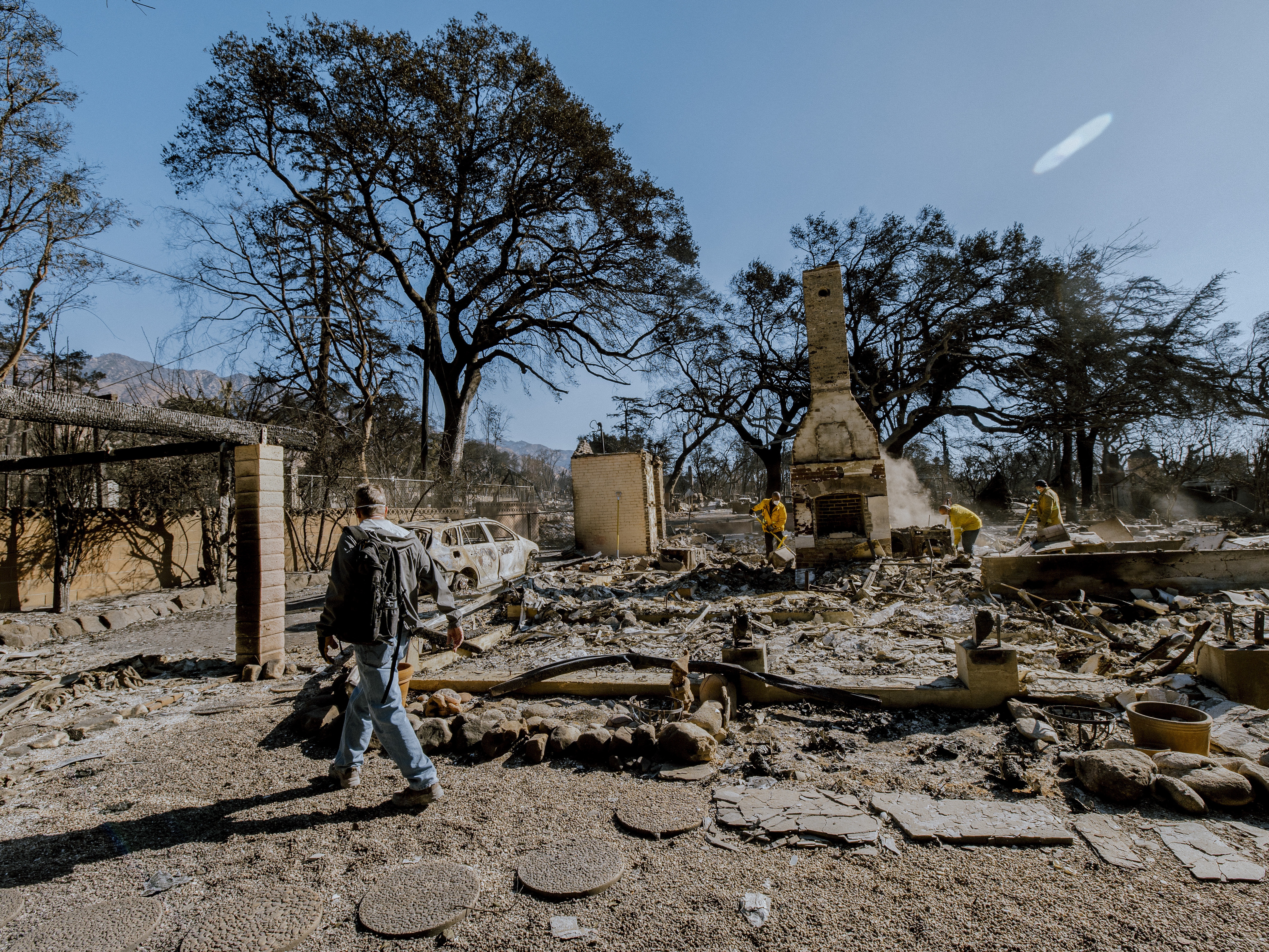 caption: A man surveys the charred remains of his home, destroyed in the Eaton Fire on Jan. 8. The house, built in 1902 and owned by his family for generations, was slated for a remodel to pass down to the next generation.