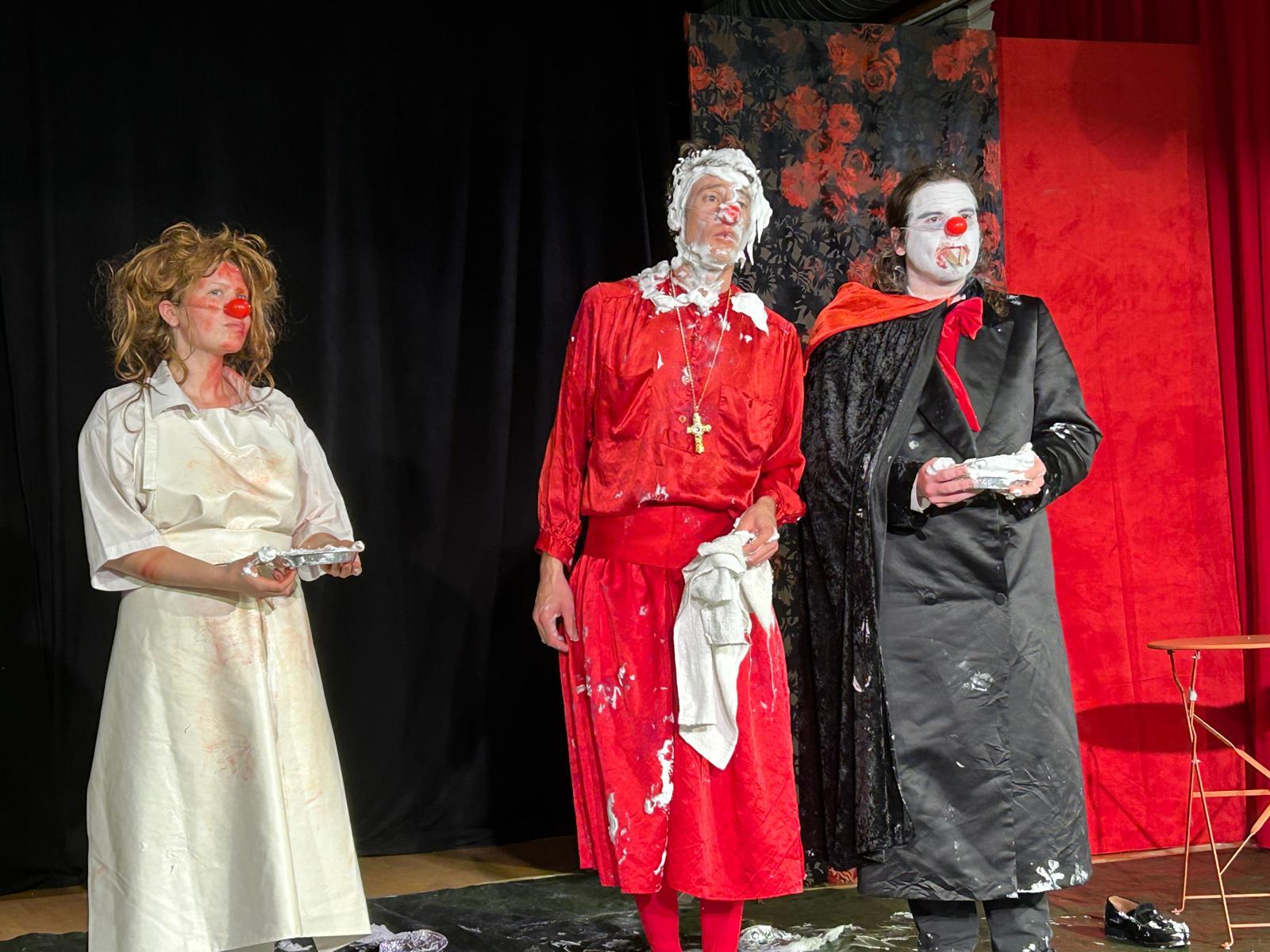 caption: From left: Gaulier students Alayna Perry, Brian Byrne and Joseph Bucci receive feedback on a short skit involving a pie in the face.
